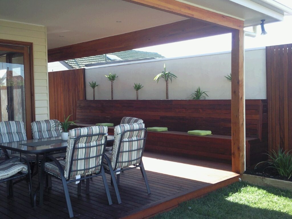 merbau timber fence with matching merbau timber decking and bench seat in outdoor living room of melbourne home